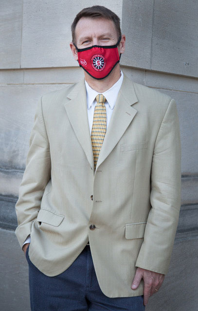 Shorewood School District Superintendent, Dr. Bryan Davis posing for a picture in front of school.