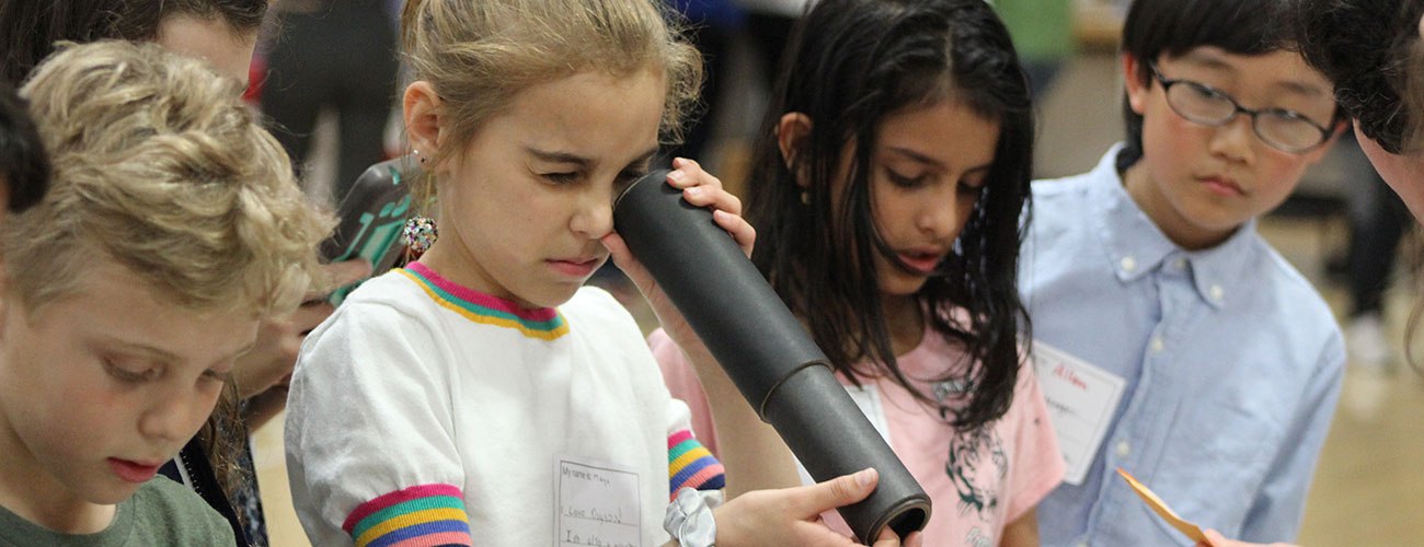 Student looking through a microscope.