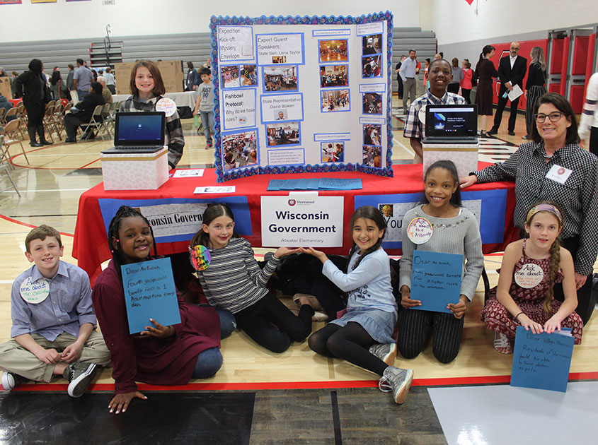 Atwater fourth grade teacher Cris Kryns with some of her students displaying their project at the Authentic Learning Showcase in Spring 2019.