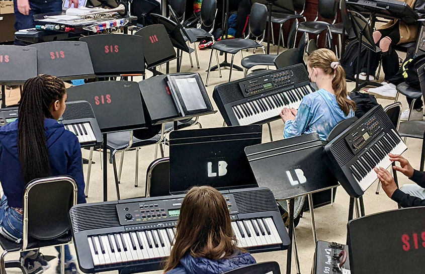 Cadet Band students learning to play keyboards.