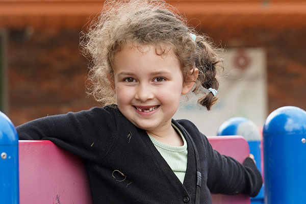 Young girl smiling on the playground.